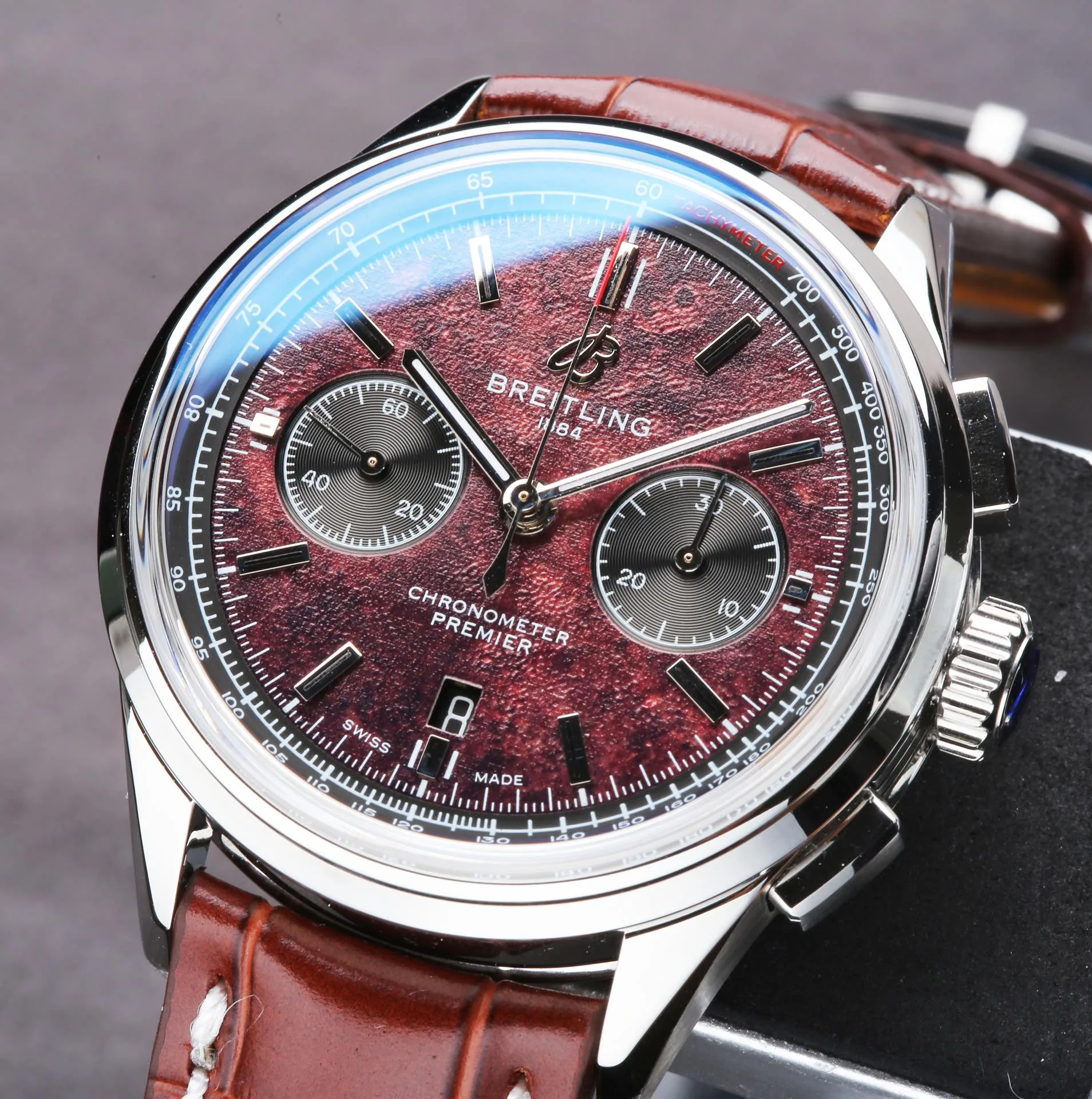 Swiss Elegant Replica Breitling Premier B01 AB01181A1Q1X2 42mm Watch – Red Dial, Brown Leather Strap